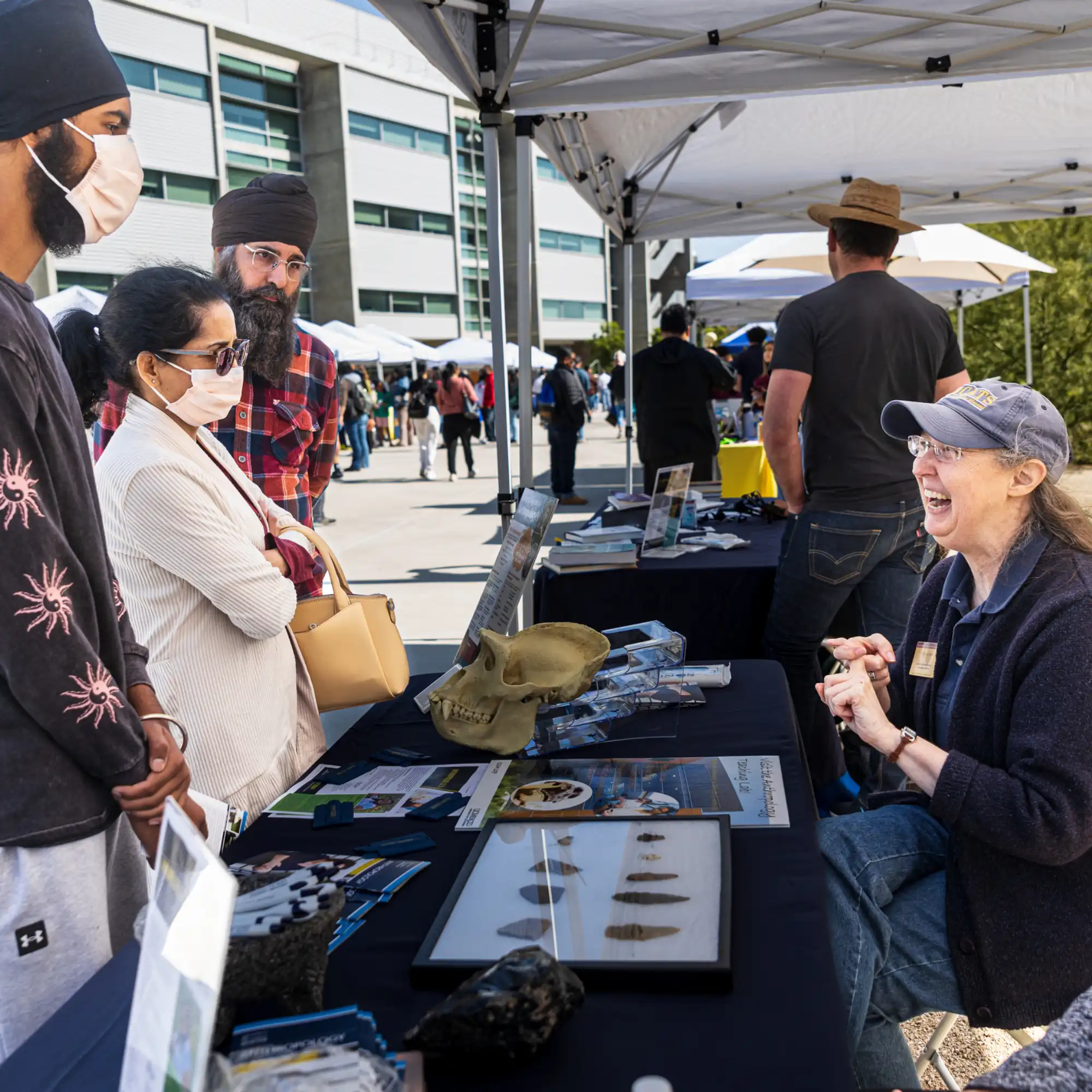 Students talking with a UC Merced booth during Bobcat Day.